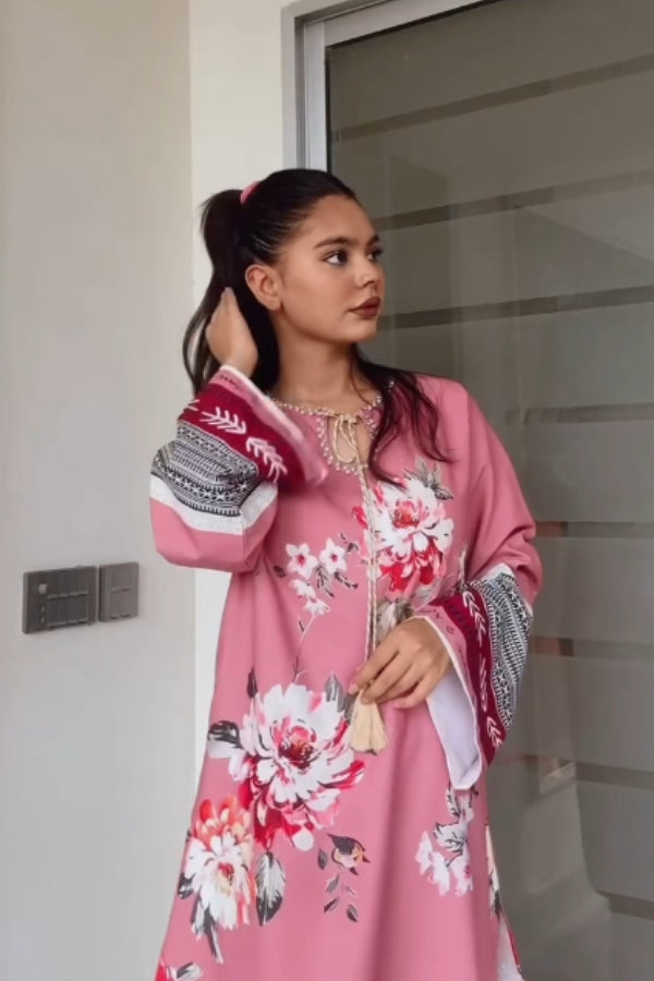 Woman wearing a pink floral dress with a white background