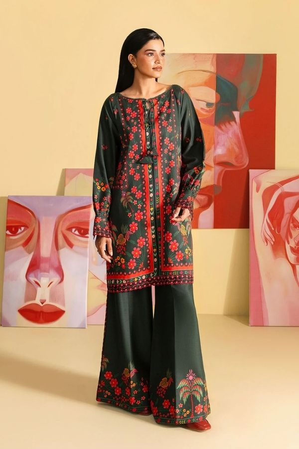 Woman wearing a black floral embroidered outfit with abstract art in the background