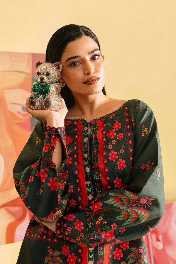 Woman holding a teddy bear with a colorful background