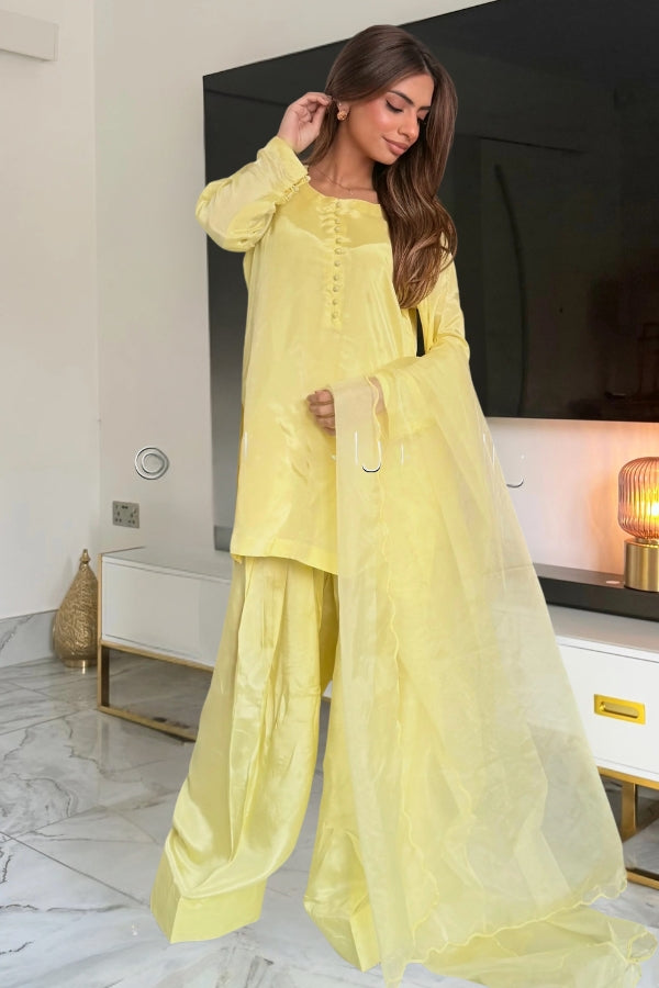 Woman wearing a yellow outfit in a modern room setting
