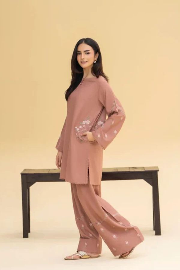 Woman wearing a pink outfit with star patterns on a beige background