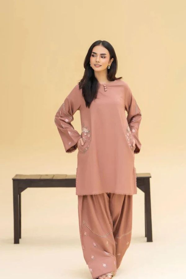 Woman wearing a pink traditional outfit with a beige background