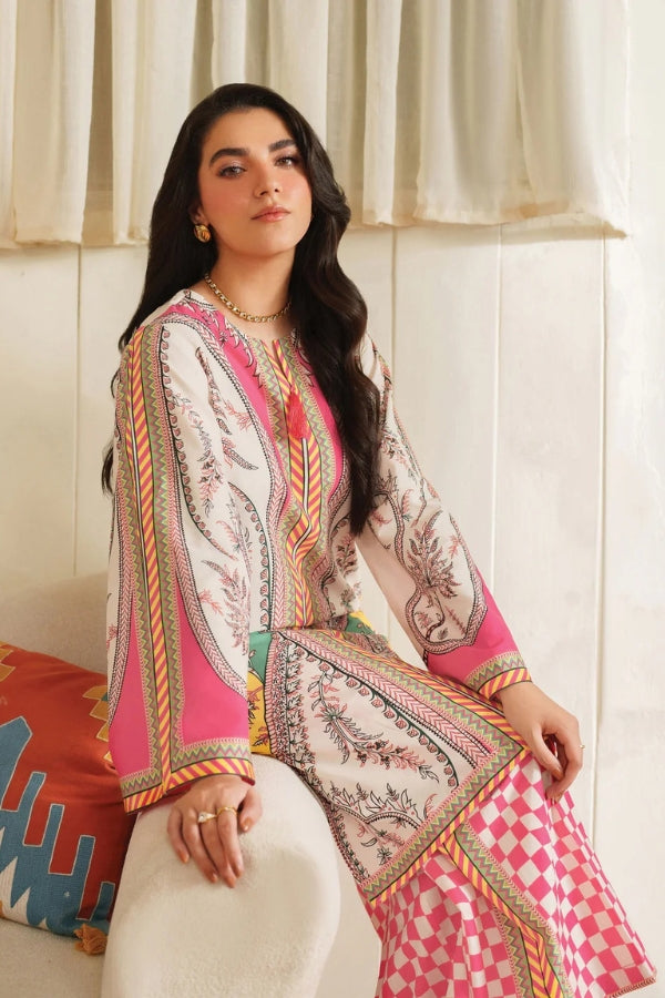 Woman wearing a colorful traditional outfit with intricate patterns in a bright room.