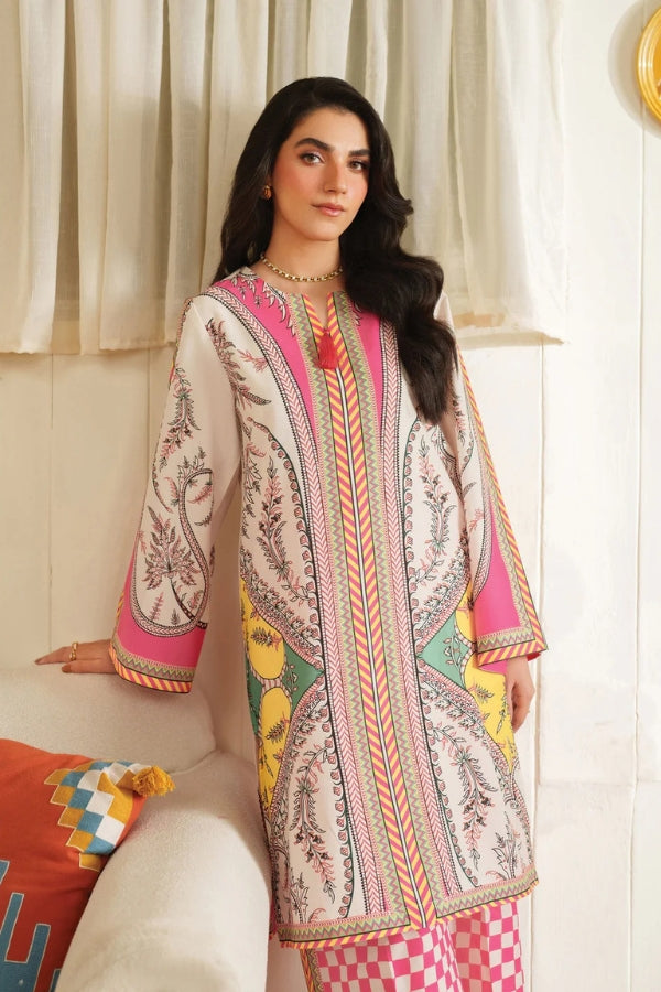 Woman wearing a colorful embroidered traditional outfit in a bright room.