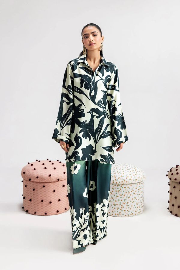 Woman wearing a floral outfit with polka dot stools in the background