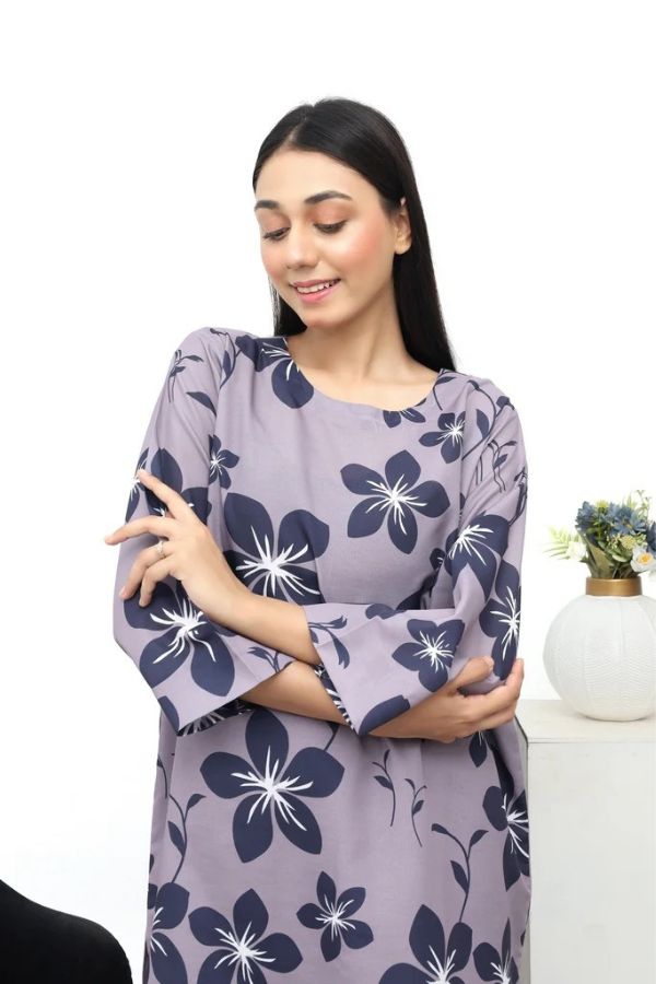 Woman wearing a purple floral dress on a white background