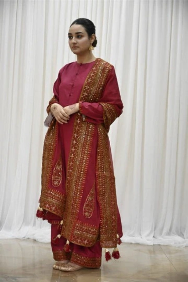 Premium maroon 3-piece festive stitched suit for women – featuring golden hand embroidery, gota work, mirror embellishments, and an embroidered chiffon dupatta with tassels – traditional Pakistani outfit perfect for Eid, mehndi, and formal events.