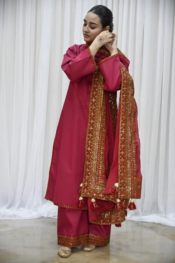 Premium maroon 3-piece festive stitched suit for women – featuring golden hand embroidery, gota work, mirror embellishments, and an embroidered chiffon dupatta with tassels – traditional Pakistani outfit perfect for Eid, mehndi, and formal events.