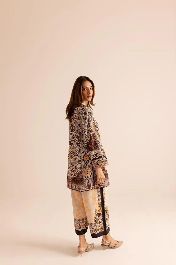Woman wearing a patterned outfit on a beige background