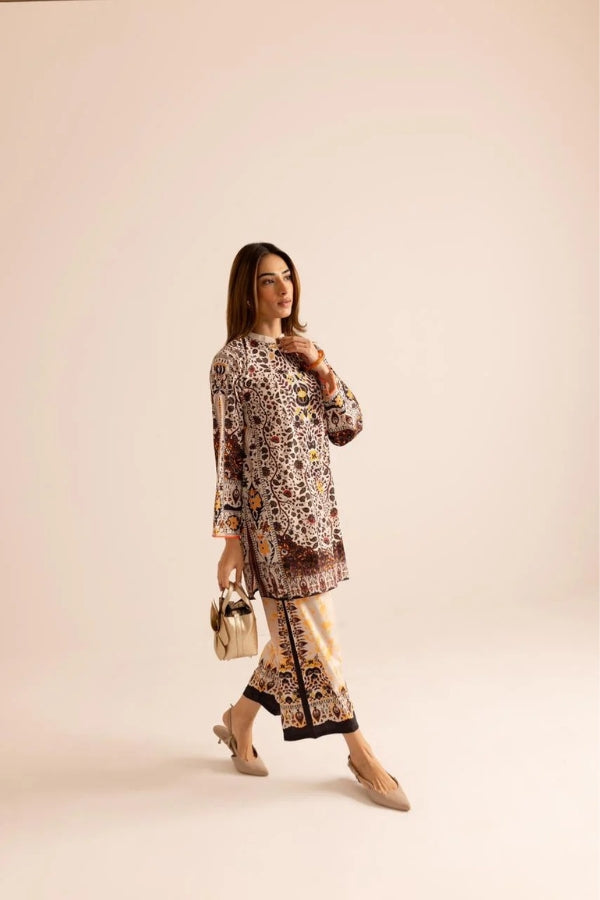 Woman wearing a patterned outfit with a beige background