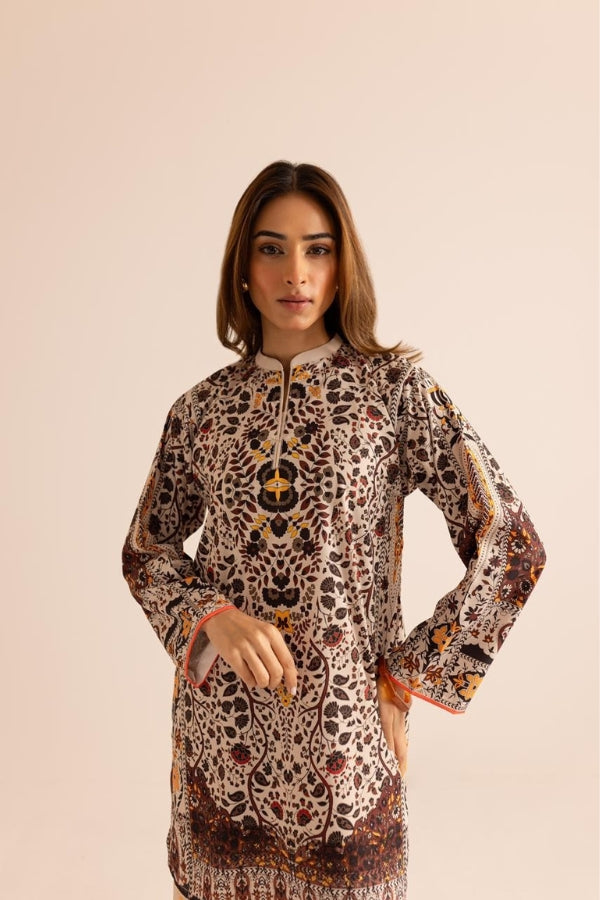 Woman wearing a patterned dress against a beige background