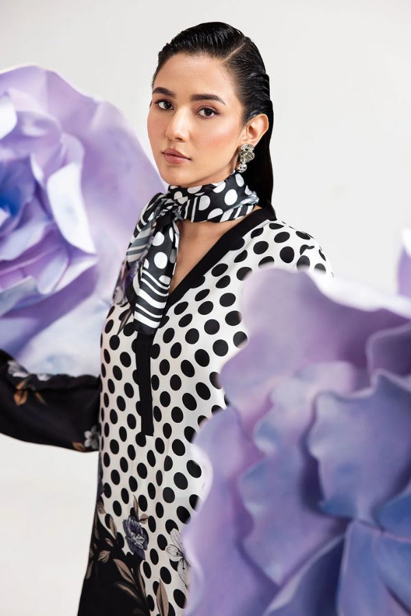 Woman wearing a polka dot scarf with purple floral background