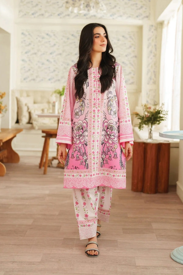 Woman wearing a pink and white traditional outfit in a well-lit room.
