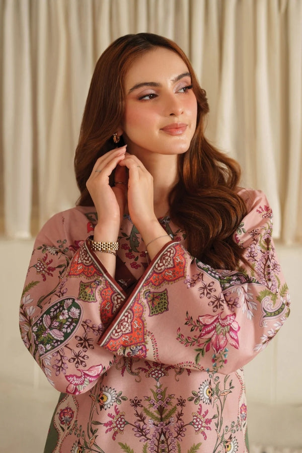 Woman wearing a pink floral dress with a neutral background