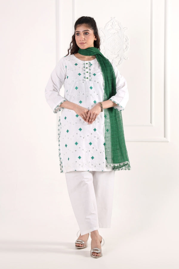 Woman wearing a white kurta with green patterns and a green scarf on a white background