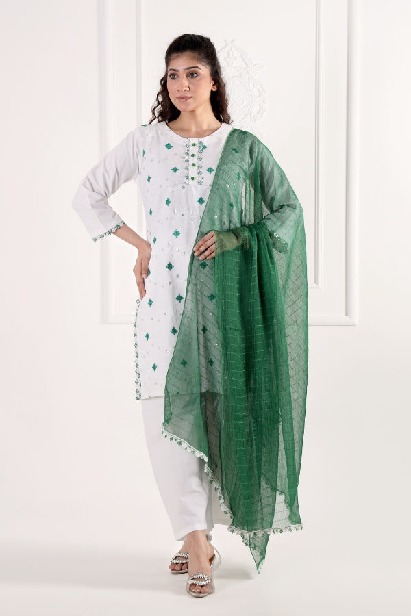 Woman wearing a white outfit with a green dupatta against a white background