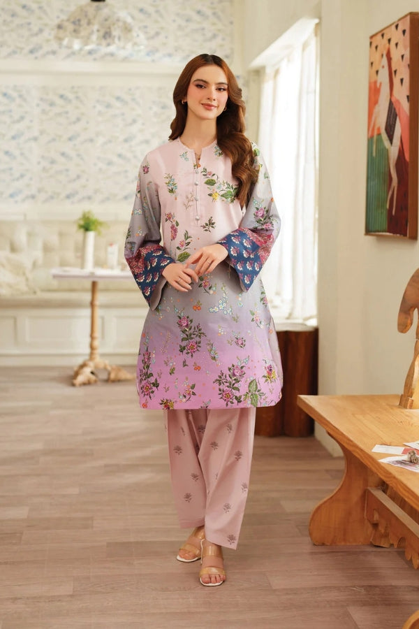 Woman in a floral outfit standing in a room with wooden floor and furniture.