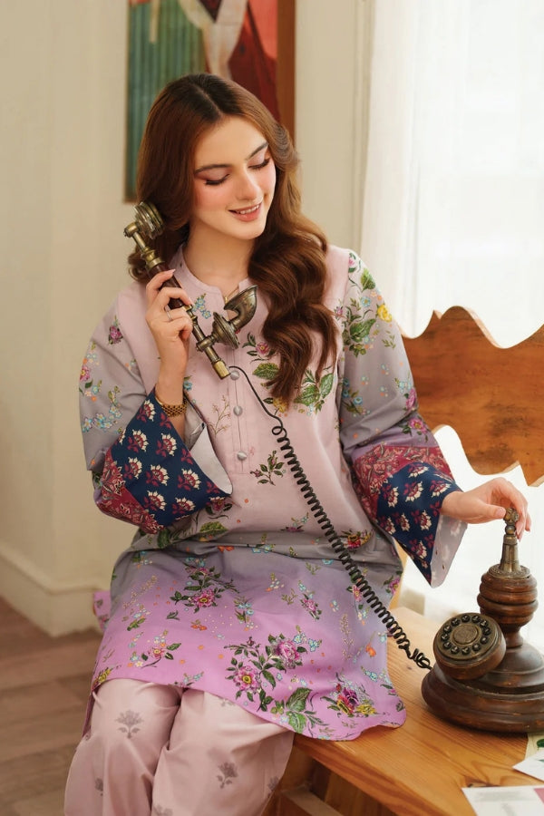 Woman in traditional outfit using a vintage phone in a room with a painting on the wall.