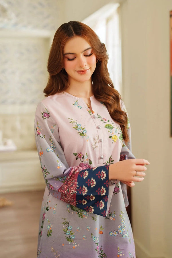 Woman wearing a floral dress with a blurred indoor background