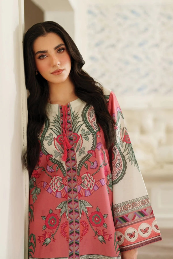 Woman wearing a pink and white embroidered traditional outfit against a blurred background