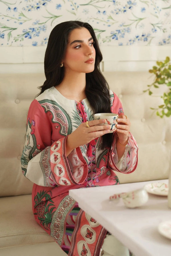Woman in a patterned outfit holding a cup in a cozy indoor setting