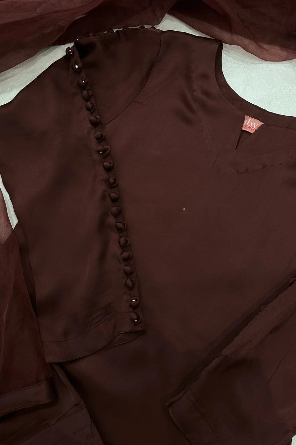 Brown garment with decorative buttons on a white background