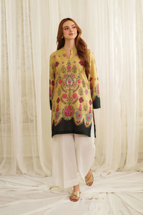 Woman wearing a yellow Printing kurta with white pants against a white curtain background